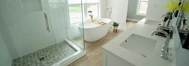 Primary bathroom with a freestanding tub, frameless glass shower and pebble-tile shower floor