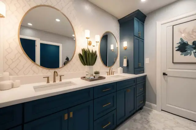 Custom navy bathroom vanity with brass pulls, white quartz top and round mirror built by C&S Remodeling in San Antonio